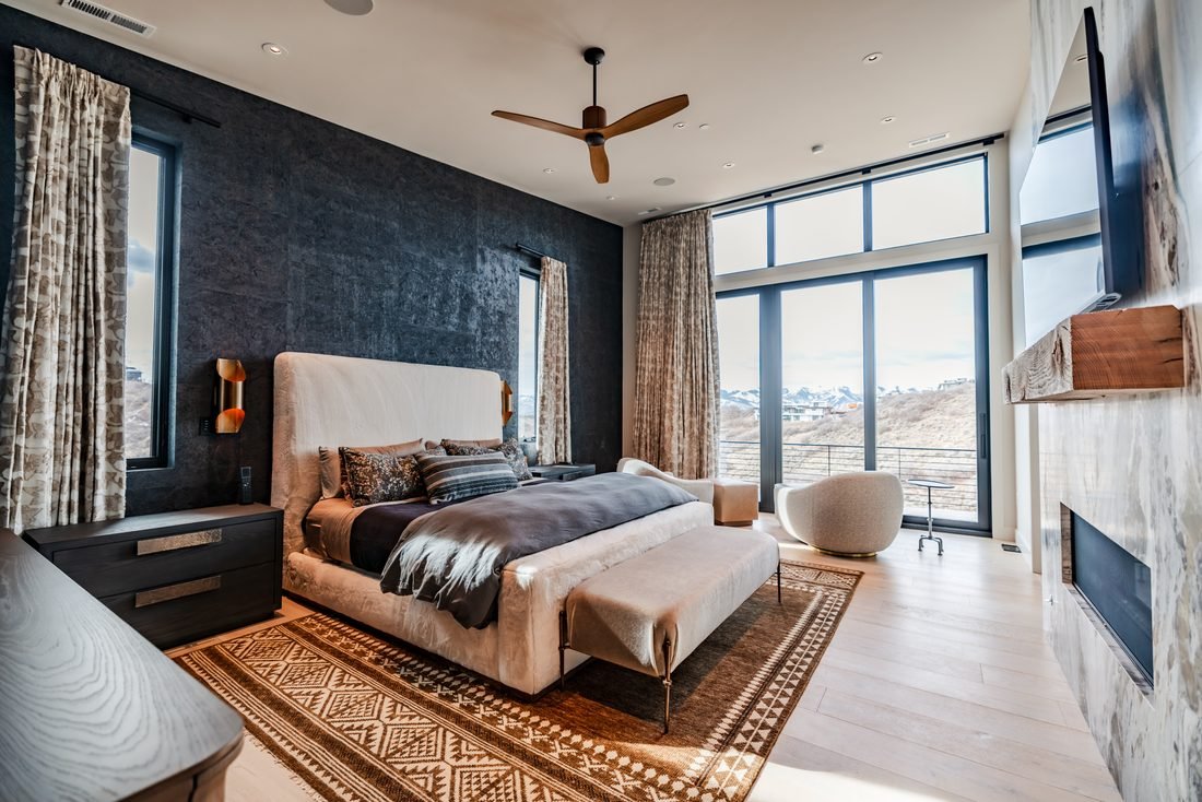 Bedroom with a dark plaster wall and a mountain view