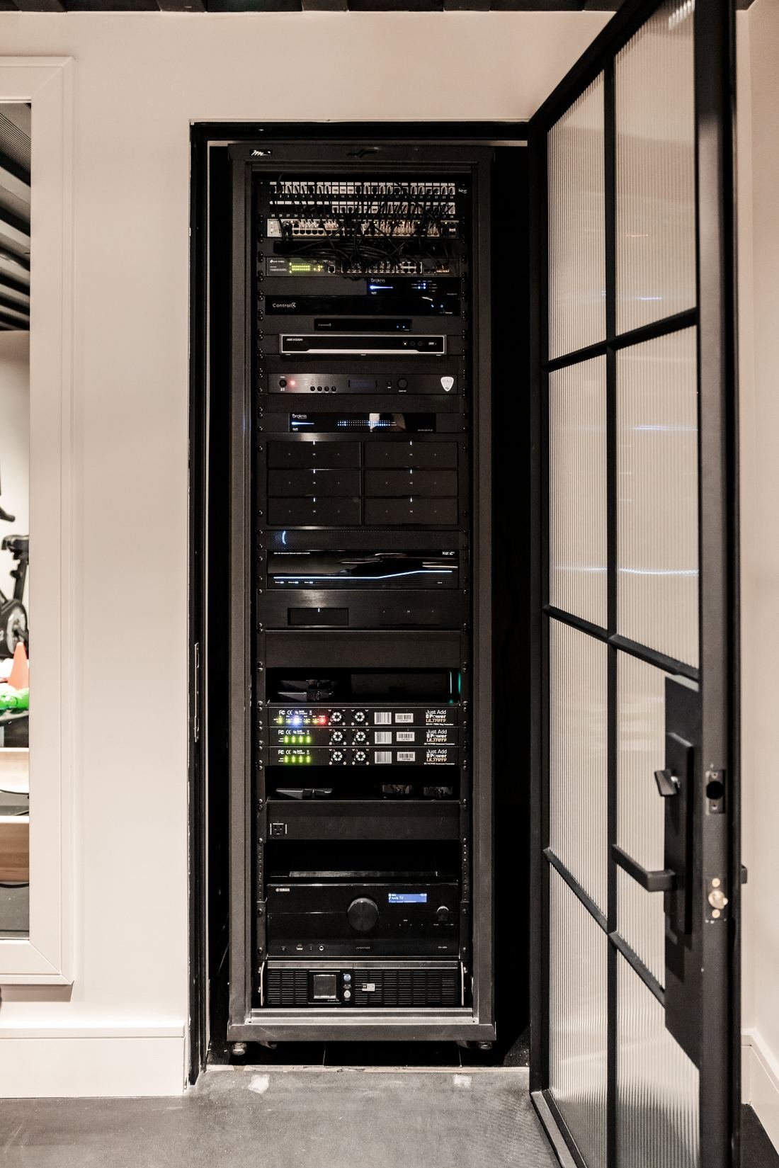 Rack of installed equipment behind glass