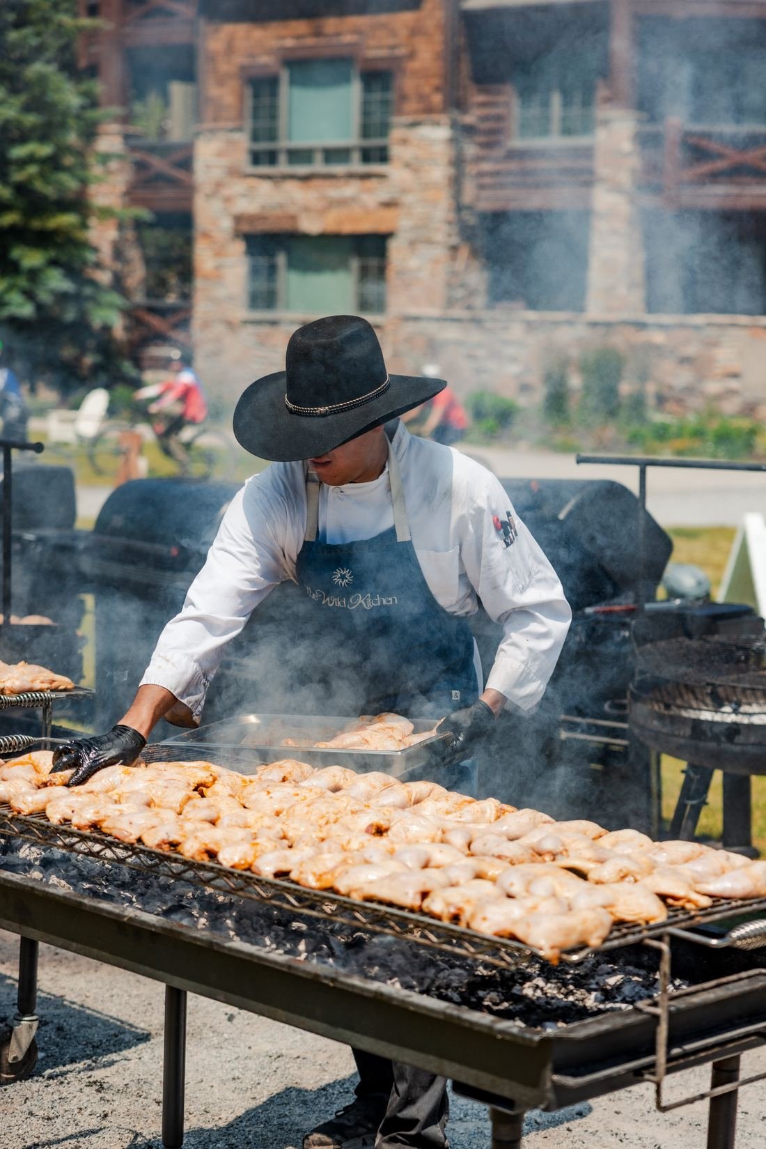 Chef working a live fire grill