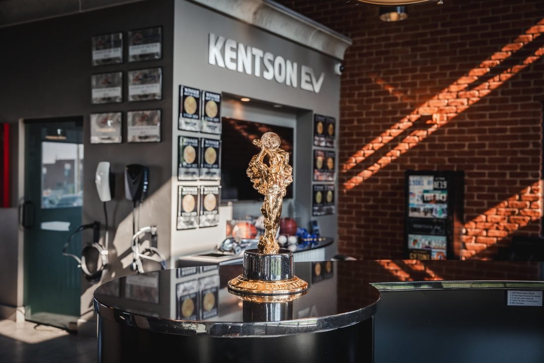 Dealership showroom desk with an award and brick walls
